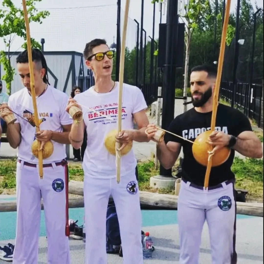 Capoeira musicians holding berimbaus